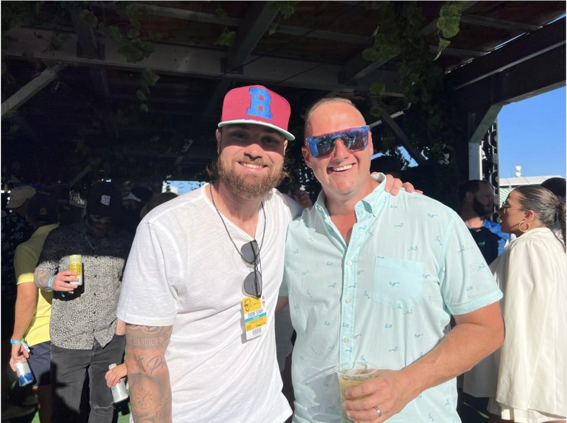Wayne Partello poses with a former minor league player he mentored on storytelling and personal branding.