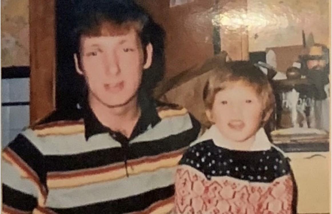 Faded childhood photo of a young Wayne Partello standing beside his father.