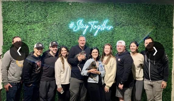 The CUENTO Marketing team posing together in front of a neon "#StayTogether" sign in Austin, TX.