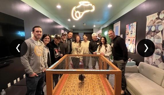 The CUENTO team gathered around a chicken-bingo table during their Austin retreat.