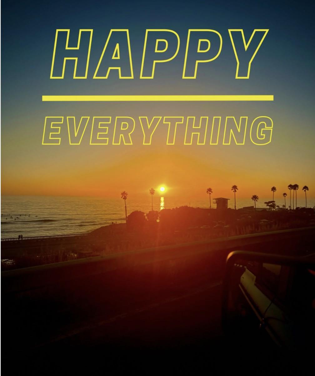 A San Diego ocean sunset with palm trees silhouetted, seen through a car window, with text overlay reading "Happy Everything."