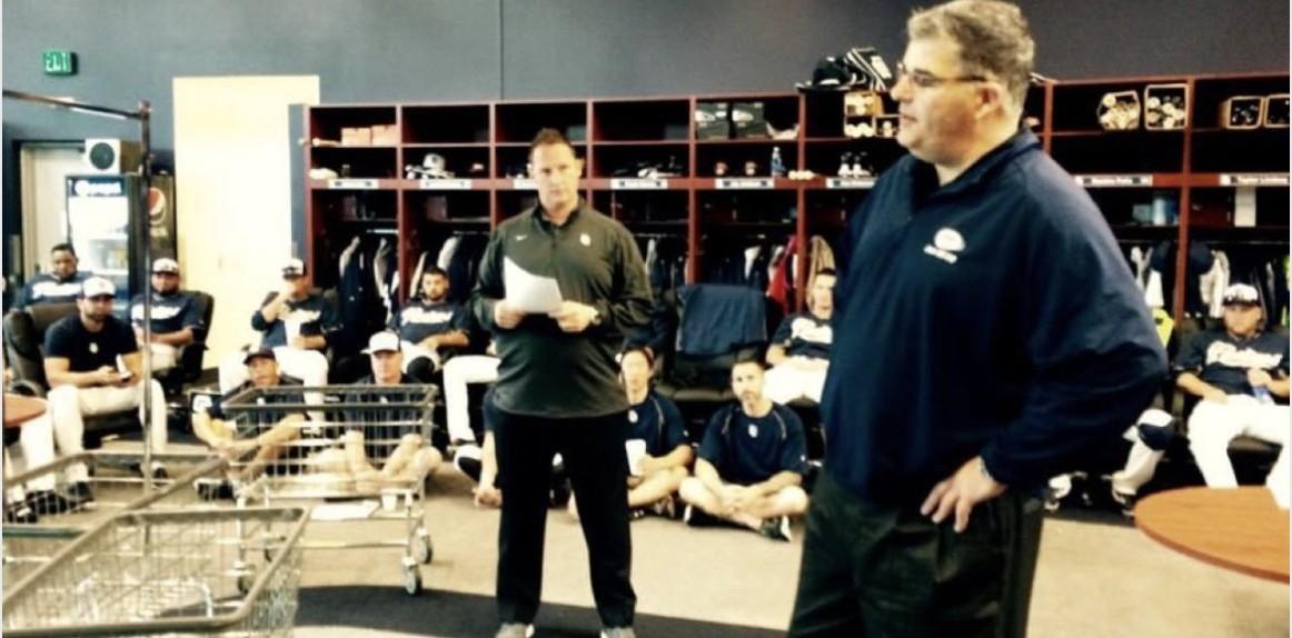 Wayne and a colleague giving a brand presentation to seated Padres players in the team clubhouse.