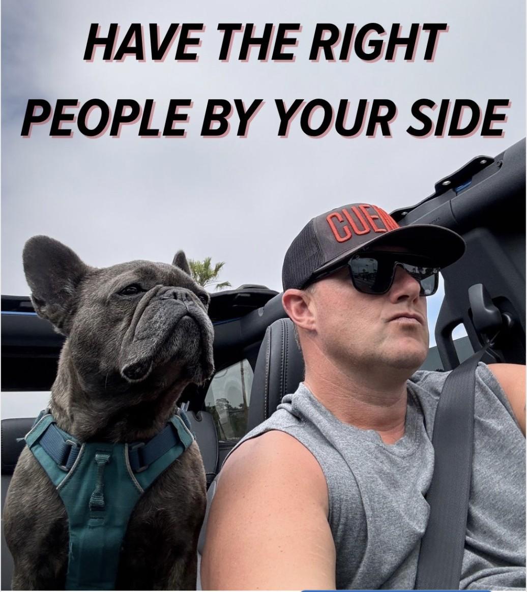 Wayne Partello driving a Jeep wearing a CUENTO cap and sunglasses, with his French Bulldog Mojo riding alongside him, captioned 'Have the Right People By Your Side'