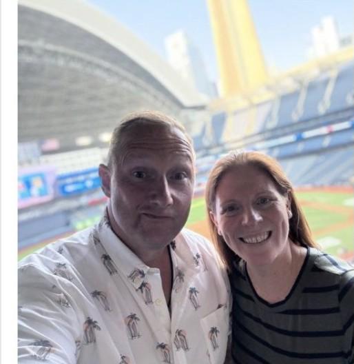Wayne Partello taking a selfie with a colleague inside the Rogers Centre stadium bowl in Toronto