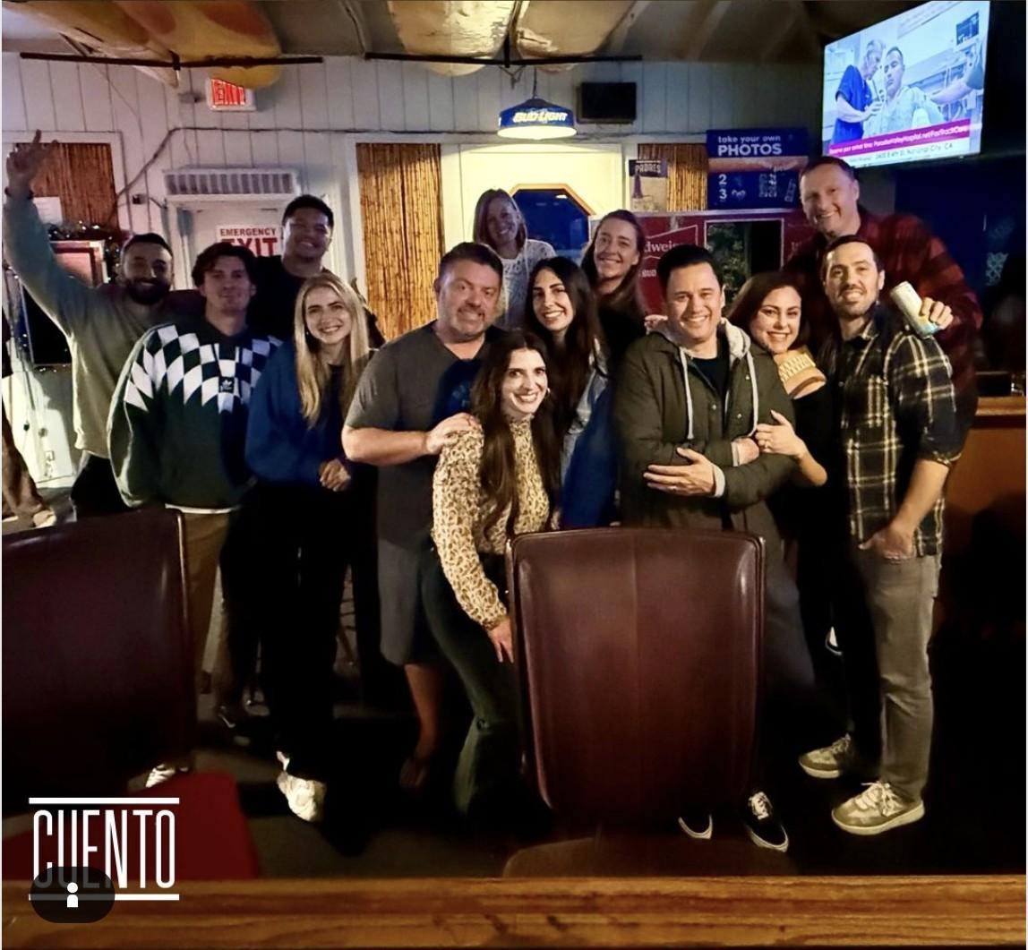 The CUENTO Marketing team posing together at a karaoke bar during their annual staff retreat.